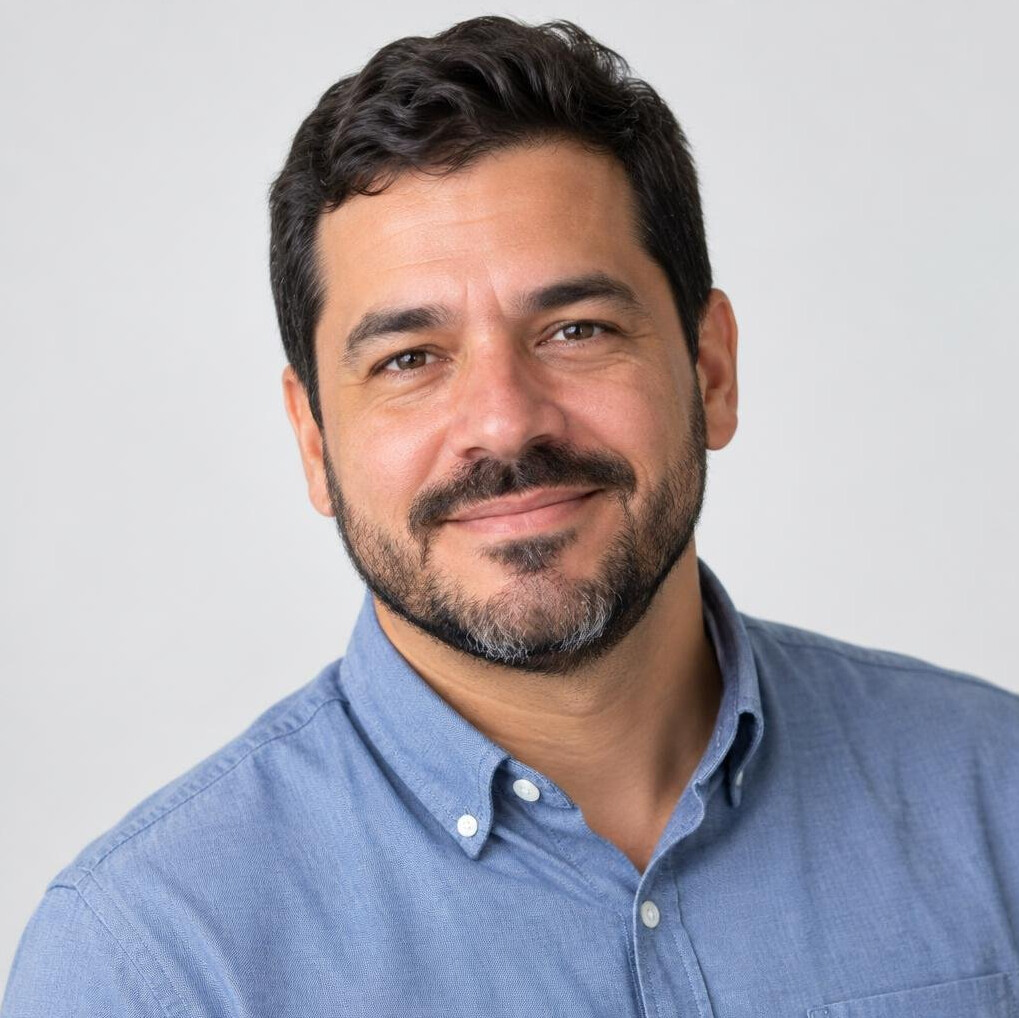 Studio portrait of a Brazilian man with short beard smiling